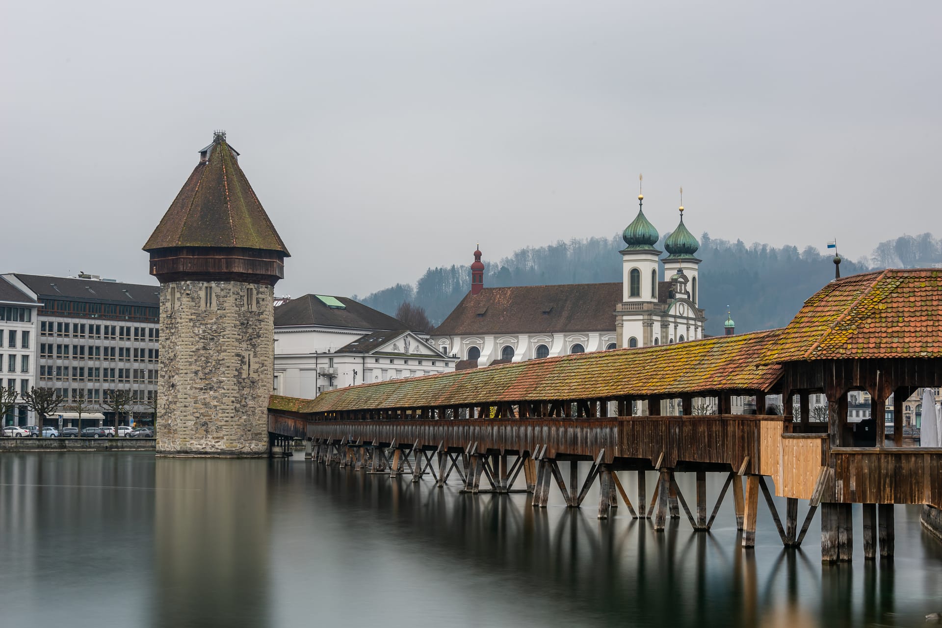 lucerne-jesuit-church-surrounded-by-water-cloudy-sky-lucerne-switzerland